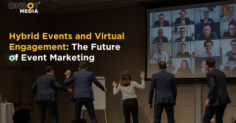 Hybrid event featuring in-person attendees and virtual participants on a video conference screen.
