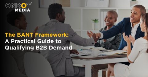 Business professionals discussing the BANT framework to qualify B2B demand and improve lead qualification through collaborative sales and marketing strategies.